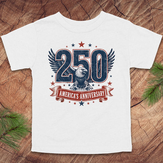 White t-shirt with '250 America's Anniversary' design featuring an eagle on a wooden surface.