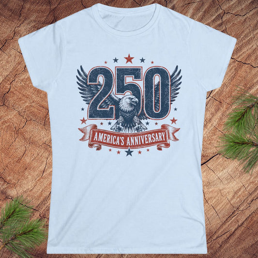 Light blue t-shirt with '250 America's Anniversary' design on a wooden surface