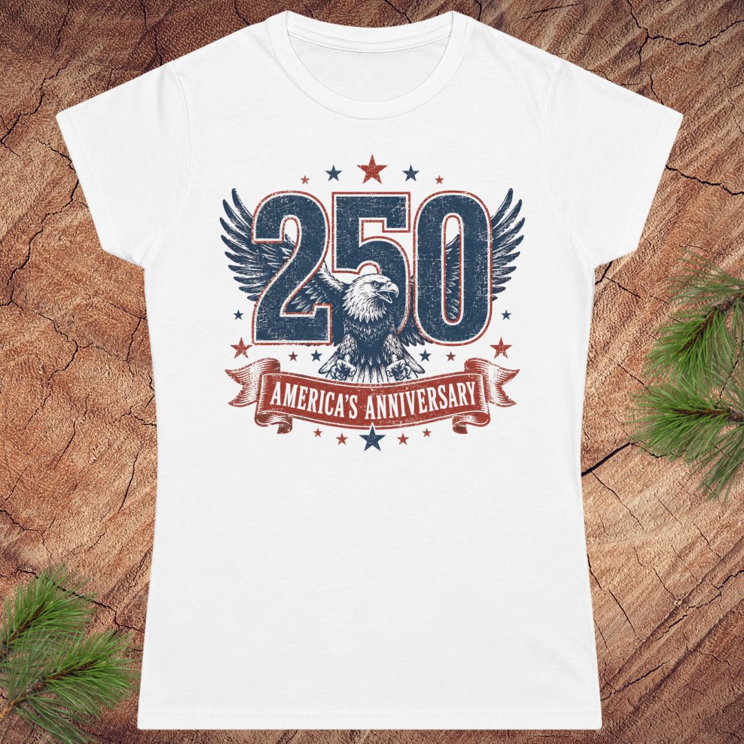 White t-shirt with '250 America's Anniversary' design on a wooden surface