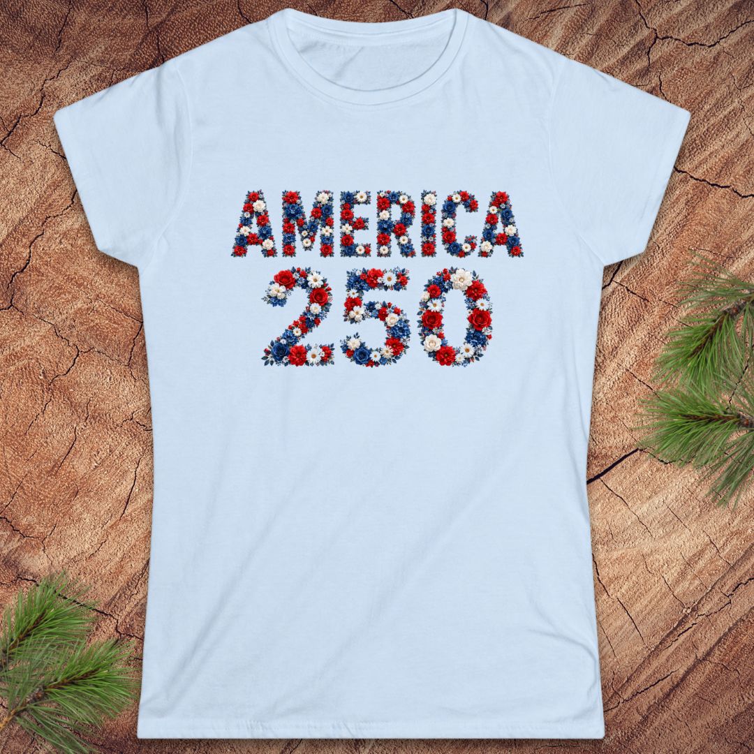 Light blue t-shirt with 'AMERICA 250' design on a wooden surface