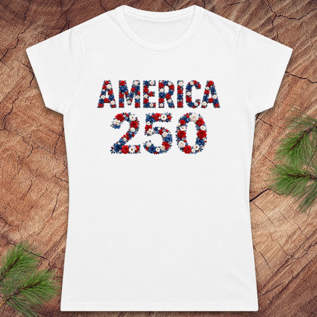 White t-shirt with 'AMERICA 250' printed in red, blue, and white on a wooden surface.