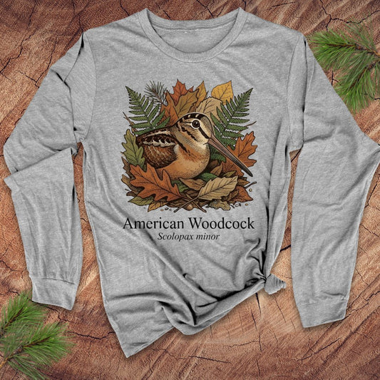 Gray long-sleeve shirt with American Woodcock design on a wooden surface