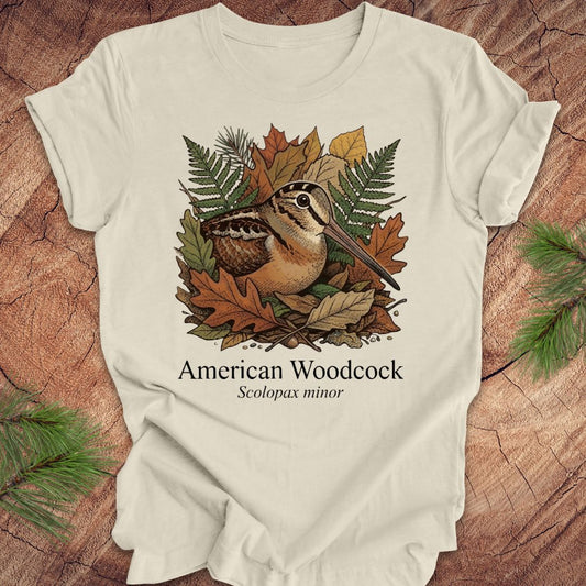 Beige t-shirt with American Woodcock design on a wooden surface