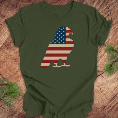 Green t-shirt with American flag eagle design on a wooden surface
