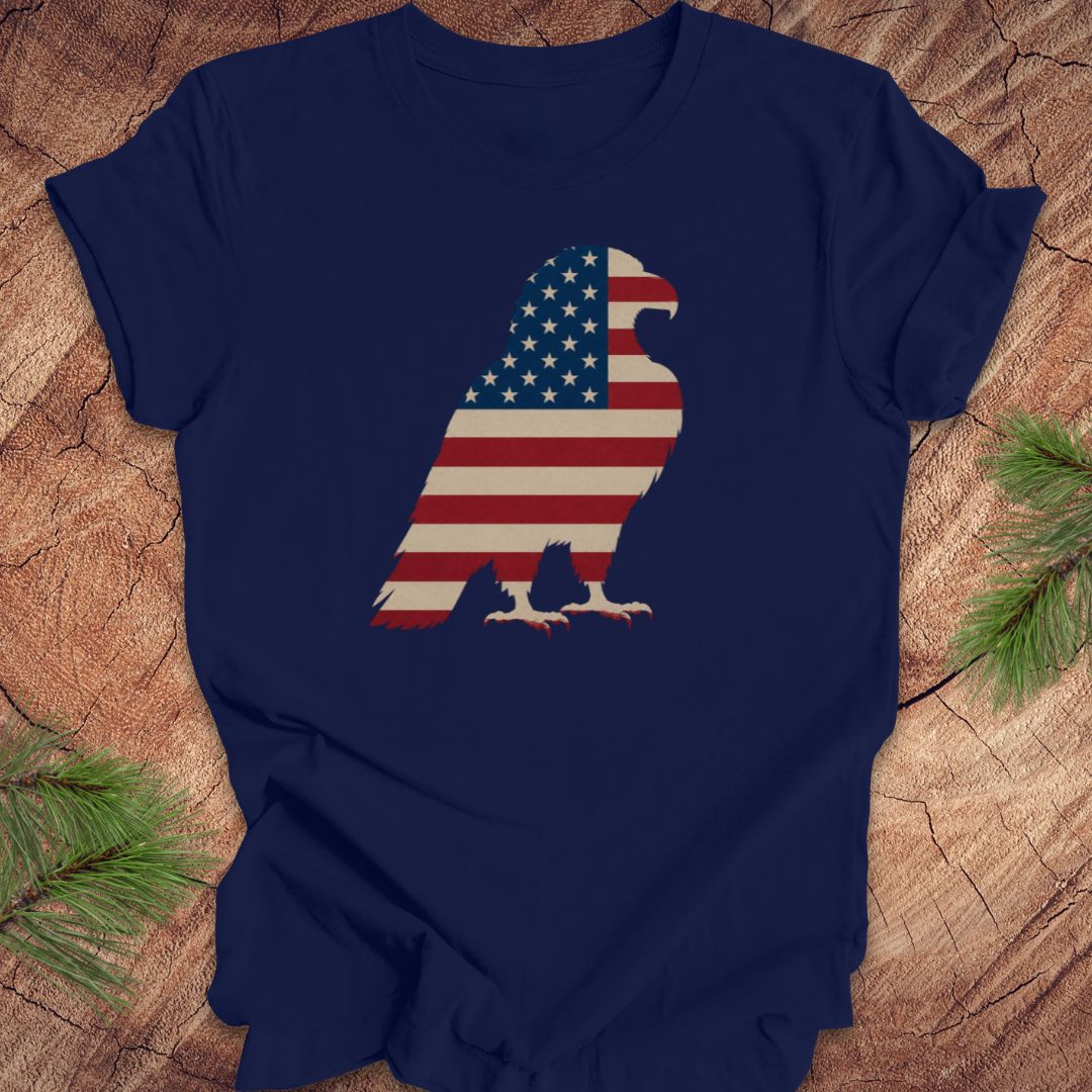 Navy blue t-shirt with American flag eagle design on a wooden surface.