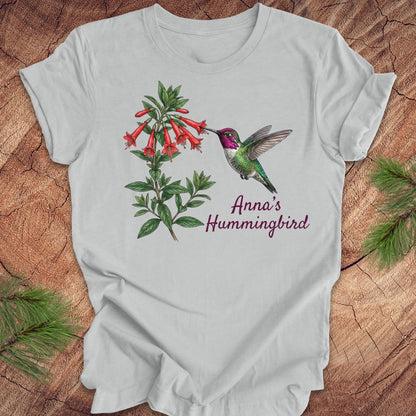 Gray t-shirt with Anna's Hummingbird design on a wooden surface