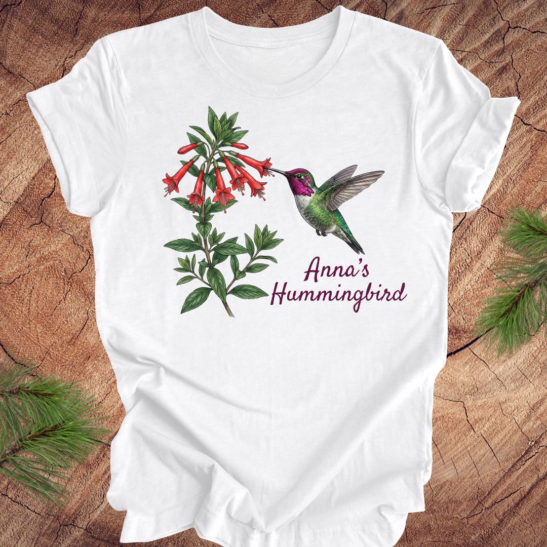 White tshirt with Anna's Hummingbird design on a wooden surface