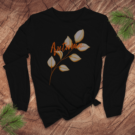 black long sleeve tshirt with the word autumn and a long stemmed leaf, on a wood background with pine leaves