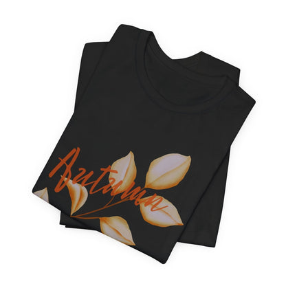 Black folded t-shirt with leaf design and "autumn" text on a white background