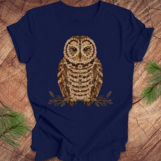 Navy blue t-shirt with an owl and flower design on a wooden surface