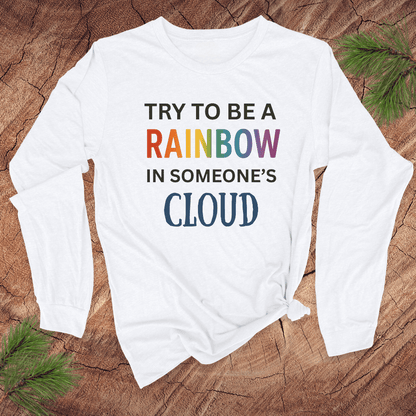 White long-sleeve shirt with colorful text on a wooden surface