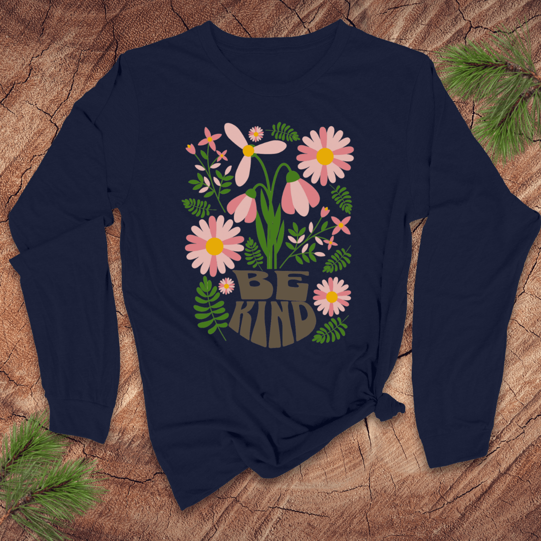 Navy blue long-sleeve shirt with floral design and 'Be Kind' text on a wooden surface.