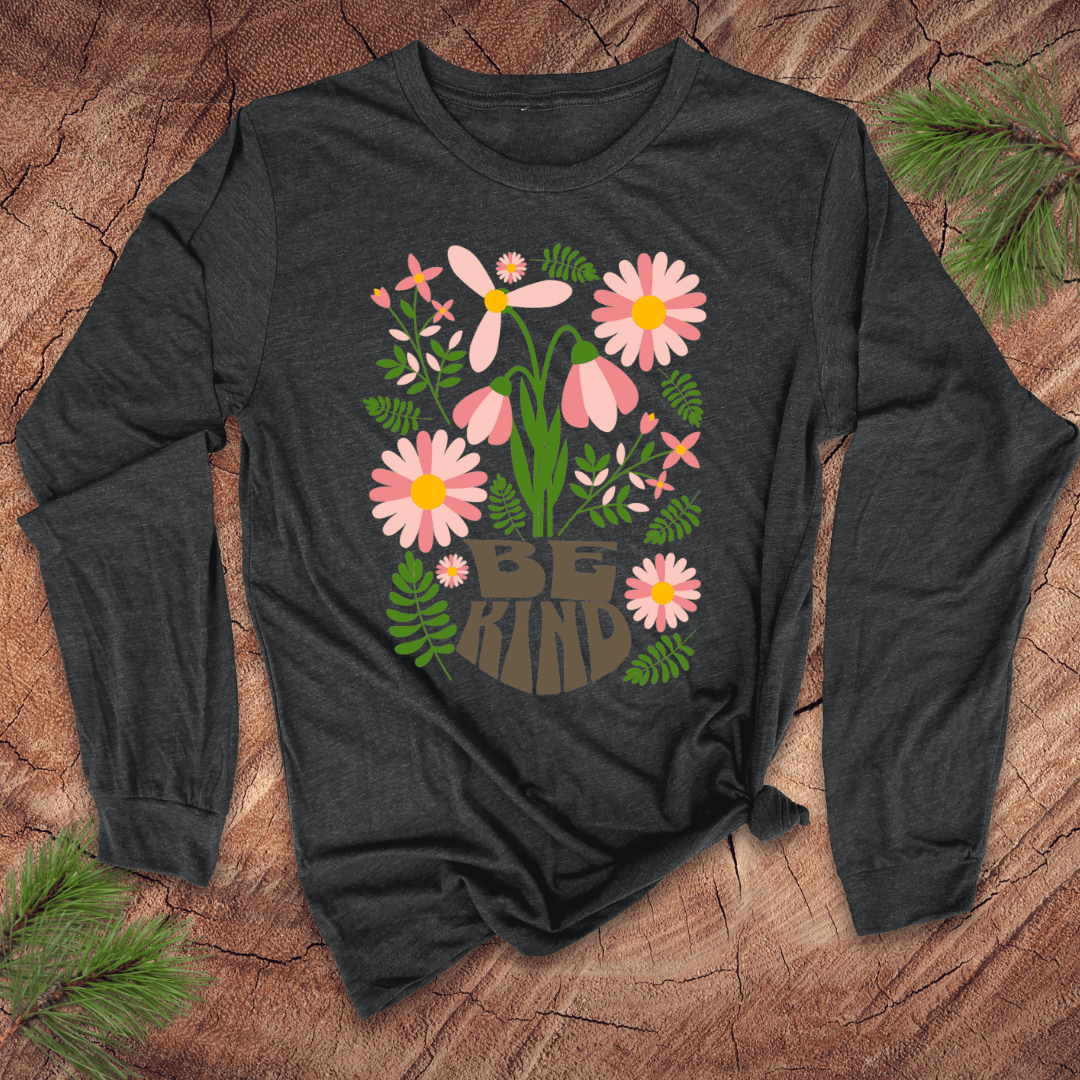 Dark long-sleeve shirt with floral design and 'Be Kind' text on a wooden surface