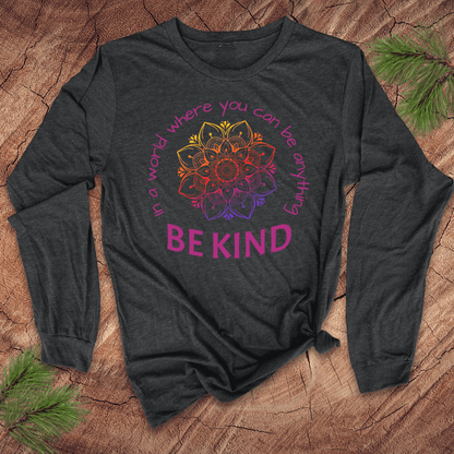 Dark gray long-sleeve shirt with a colorful mandala and 'BE KIND' text on a wooden surface.