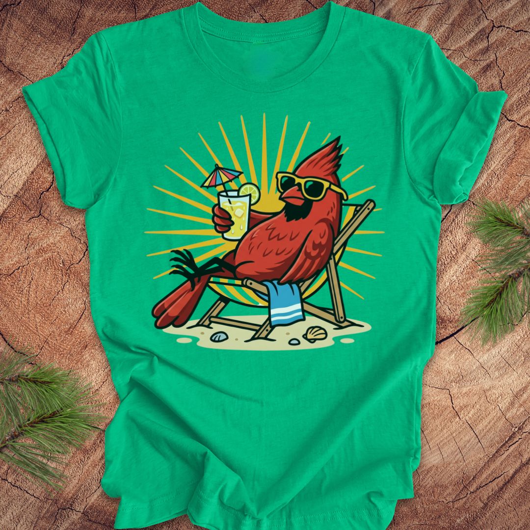 Green t-shirt with a cardinal wearing sunglasses and holding a drink on a wooden surface
