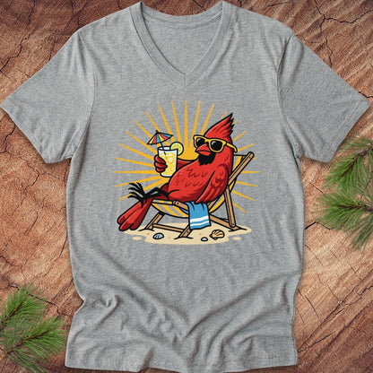 Gray t-shirt with a cardinal wearing sunglasses and a hat, holding a drink, on a wooden surface.