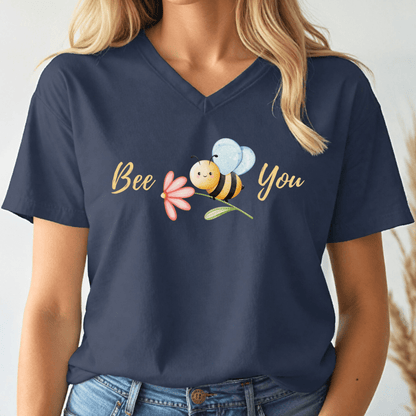 Navy blue v-neck tshirt with a cute bee and the text, "Bee You" worn by a woman.