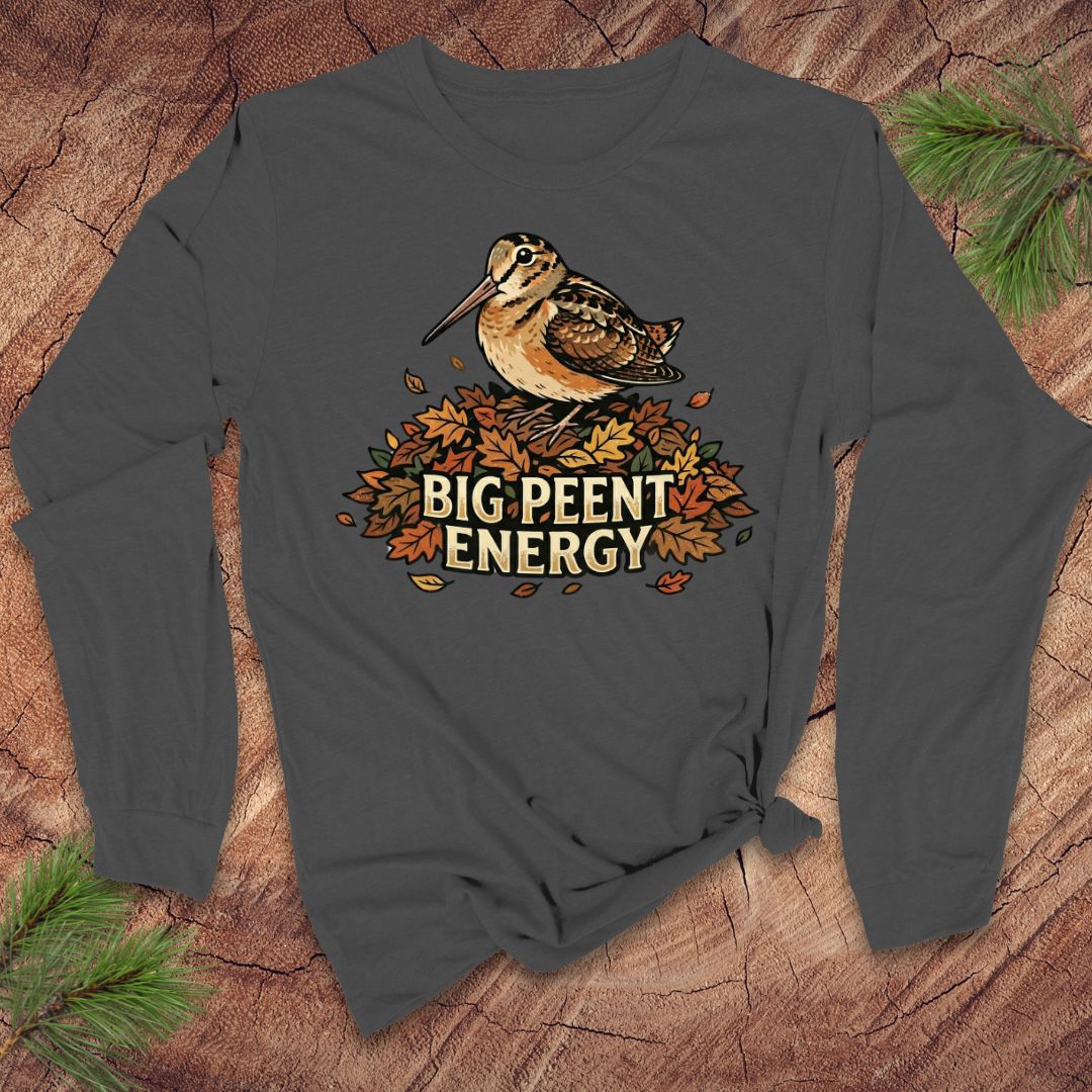 Dark gray long-sleeve shirt with a woodcock graphic and 'BIG PEENT ENERGY' text on a wooden surface.