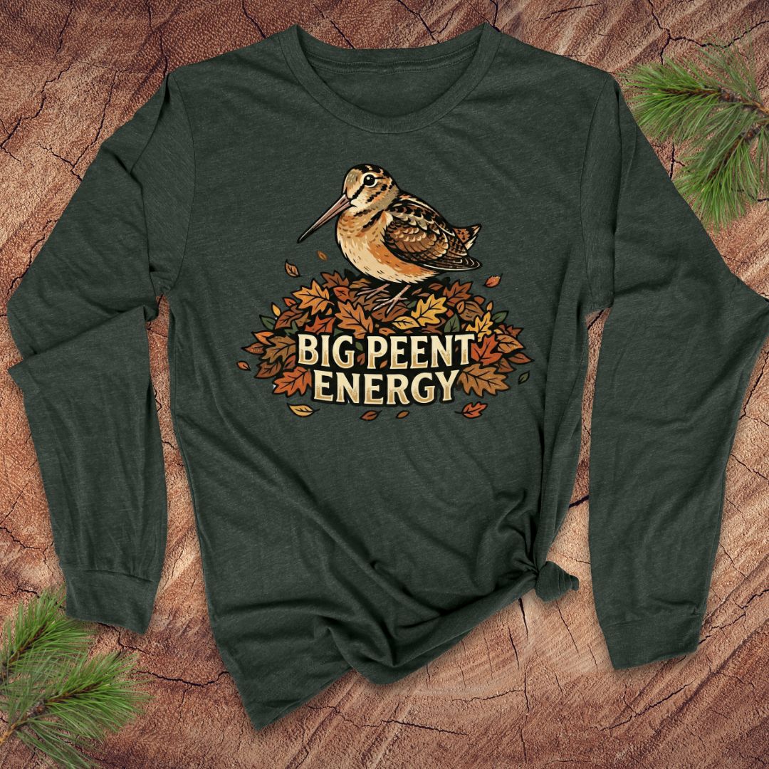 Green long-sleeve shirt with a woodcock graphic and 'BIG PEENT ENERGY' text on a wooden surface.