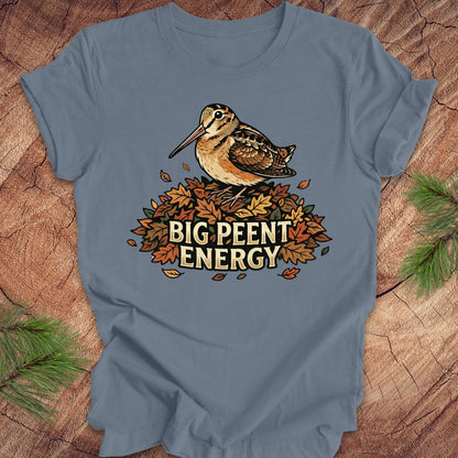 Blue t-shirt with a woodcock graphic and 'BIG PEENT ENERGY' text on a wooden surface.