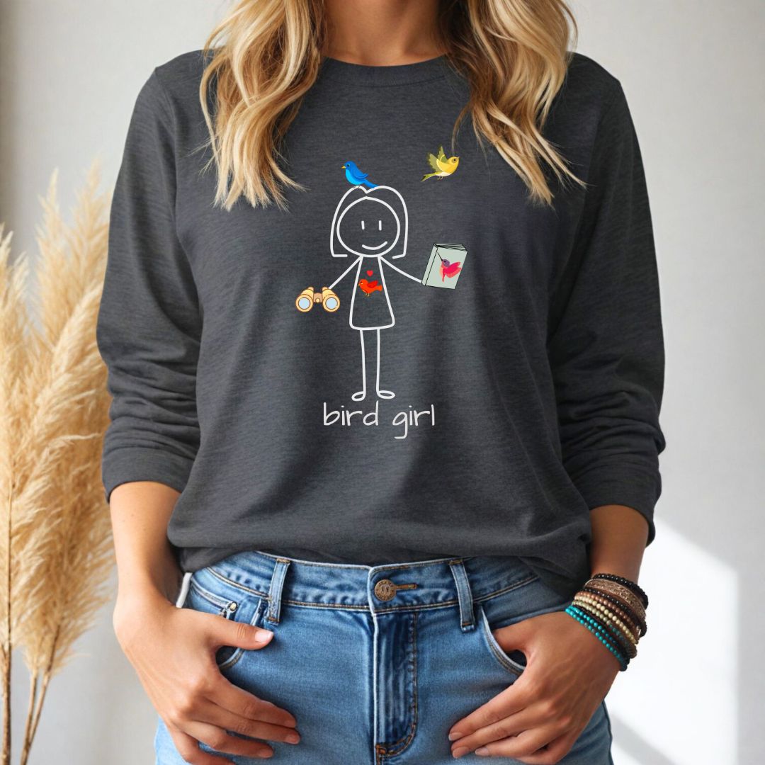 Person wearing a dark gray long sleeve shirt with a 'bird girl' graphic design, standing against a neutral background.