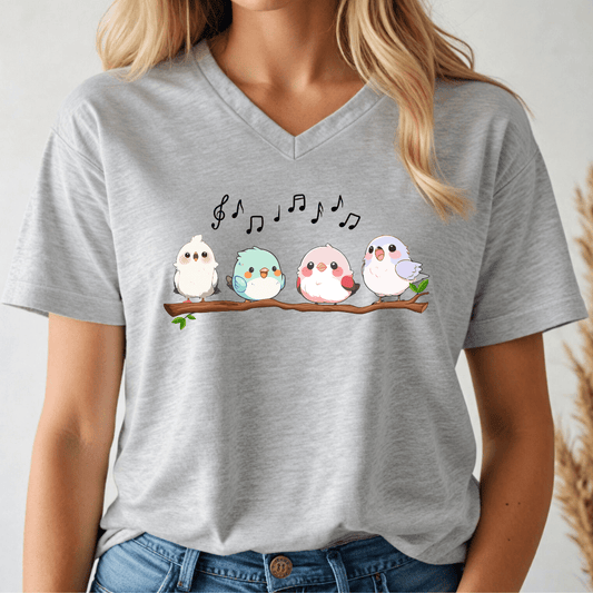 Person wearing a gray t-shirt with cartoon birds and musical notes design.