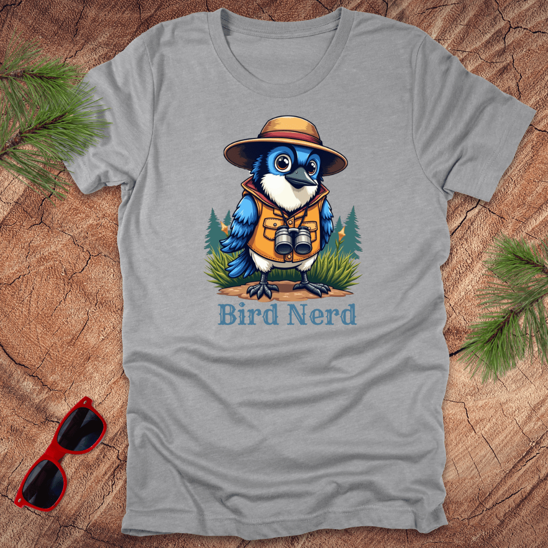 Grey t-shirt with an animated blue jay in birdwatching gear with "bird nerd" text on a wood background.