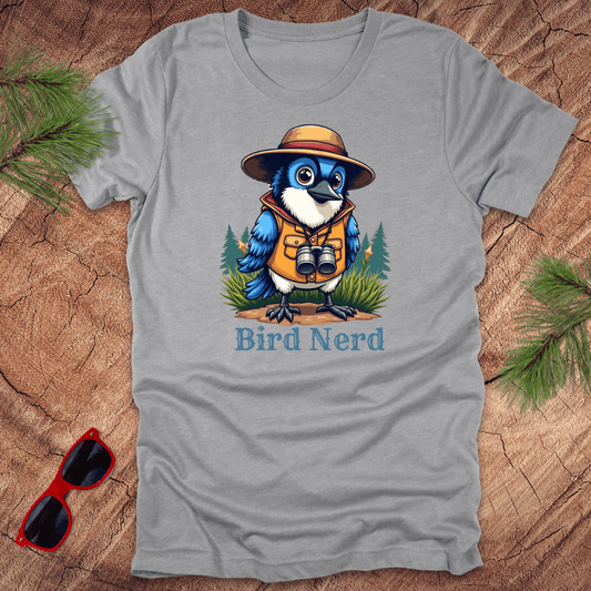 Grey t-shirt with an animated blue jay in birdwatching gear with "bird nerd" text on a wood background.