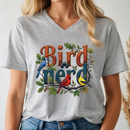 Person wearing a gray t-shirt with 'Bird Nerd' design featuring birds and leaves.