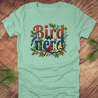 Light green t-shirt with 'Bird Nerd' graphic design featuring birds on a wooden surface.