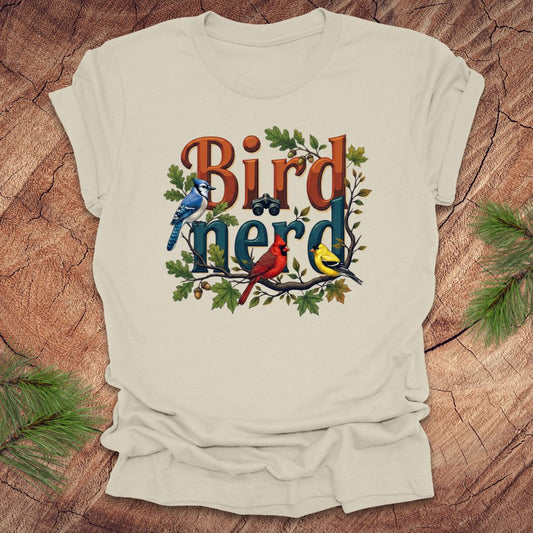 Beige t-shirt with 'Bird Nerd' design featuring birds and leaves on a wooden surface.