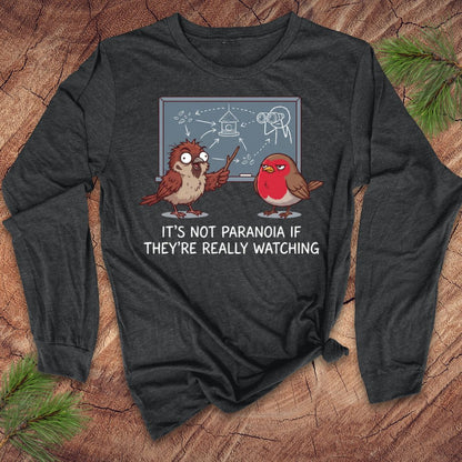 Dark long-sleeve shirt with cartoon birds and text on a wooden surface