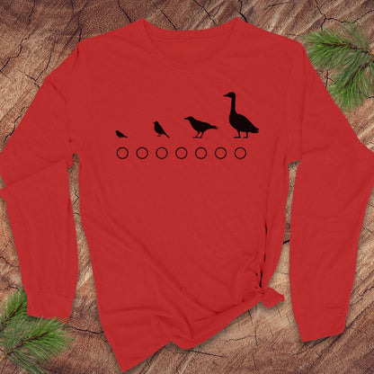 Red long-sleeve shirt with black bird illustrations on a wooden surface