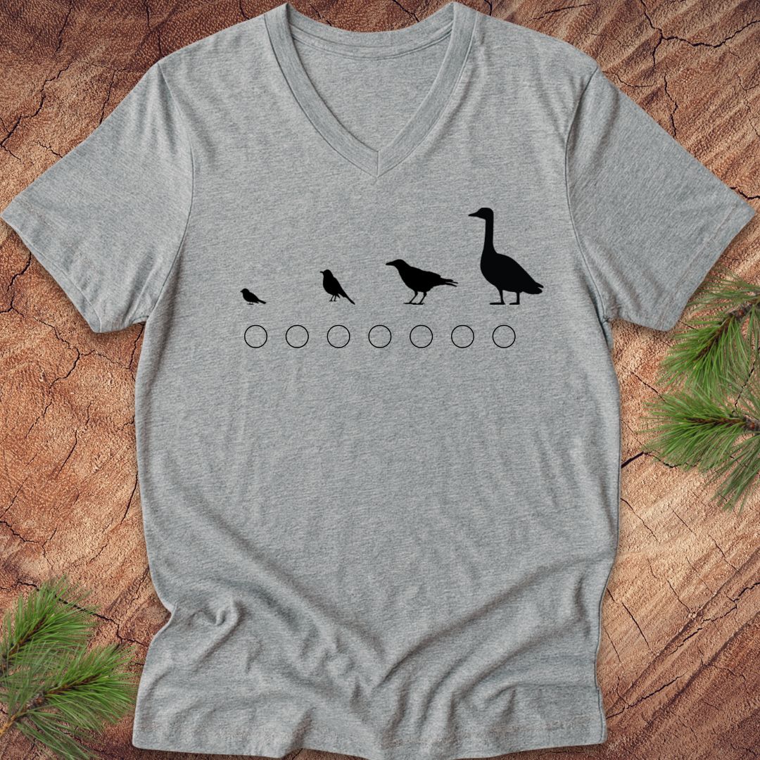 Gray v-neck t-shirt with black bird illustrations on a wooden surface