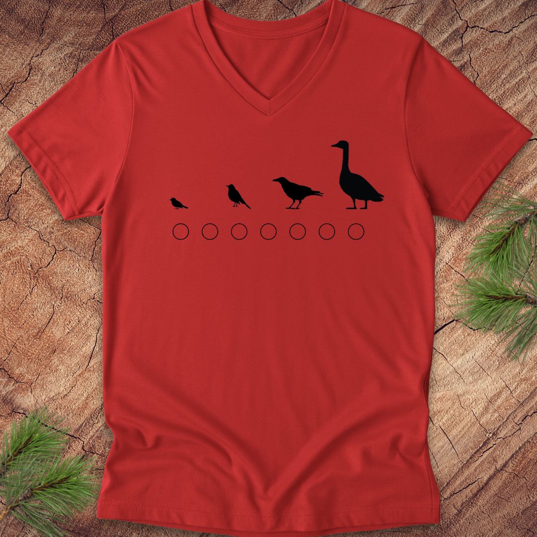 Red v-neck t-shirt with black bird illustrations on a wooden surface
