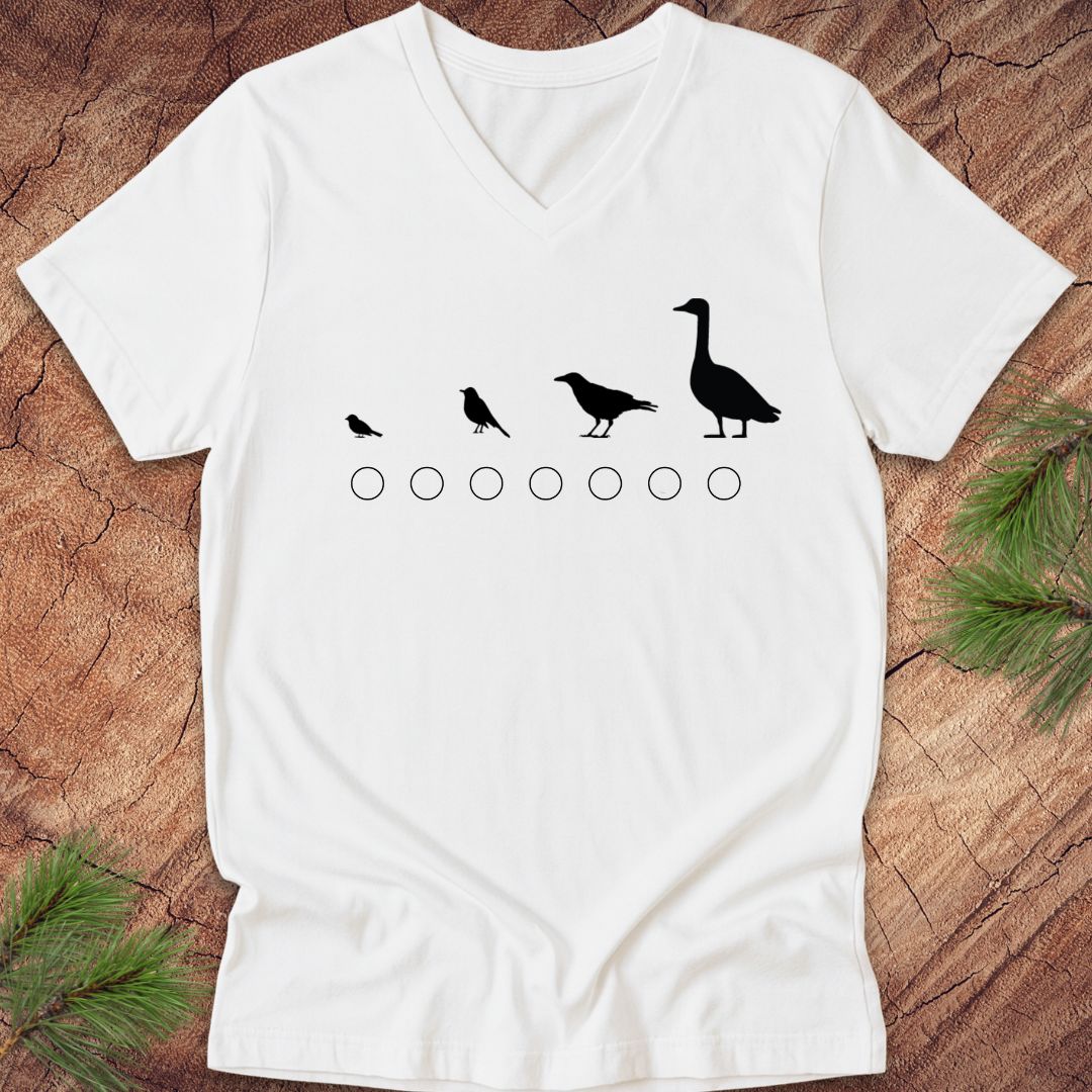 White v-neck t-shirt with black bird illustrations on a wooden surface