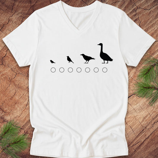 White v-neck t-shirt with black bird illustrations on a wooden surface