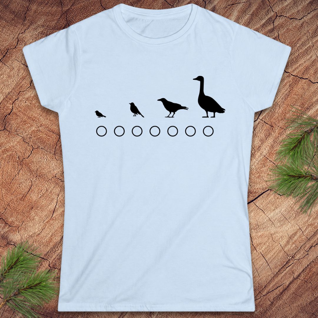 Light blue  t-shirt with black bird and circle design on a wooden surface