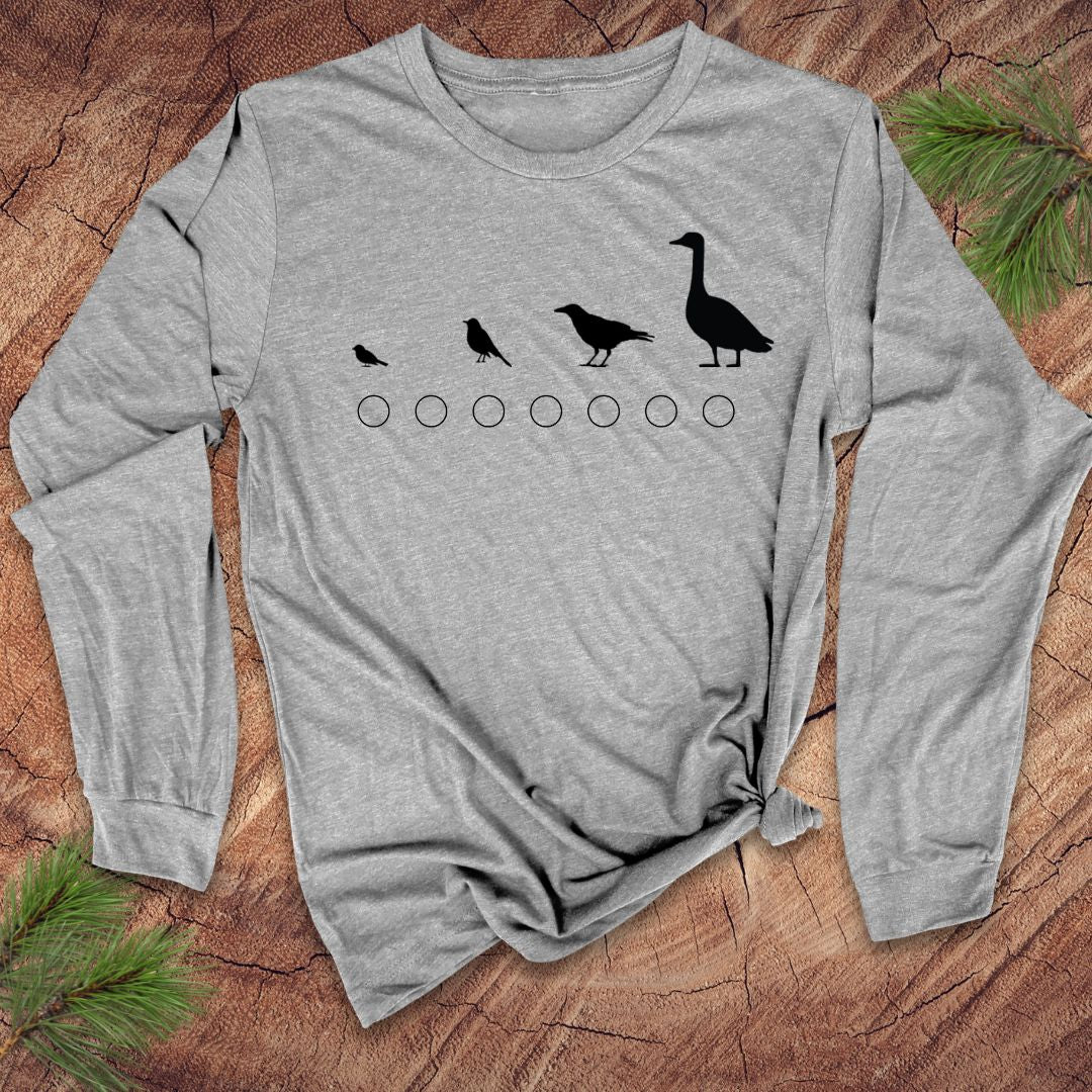 Gray long-sleeve shirt with black bird design on a wooden surface