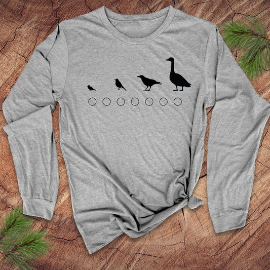 Gray long-sleeve shirt with black bird design on a wooden surface