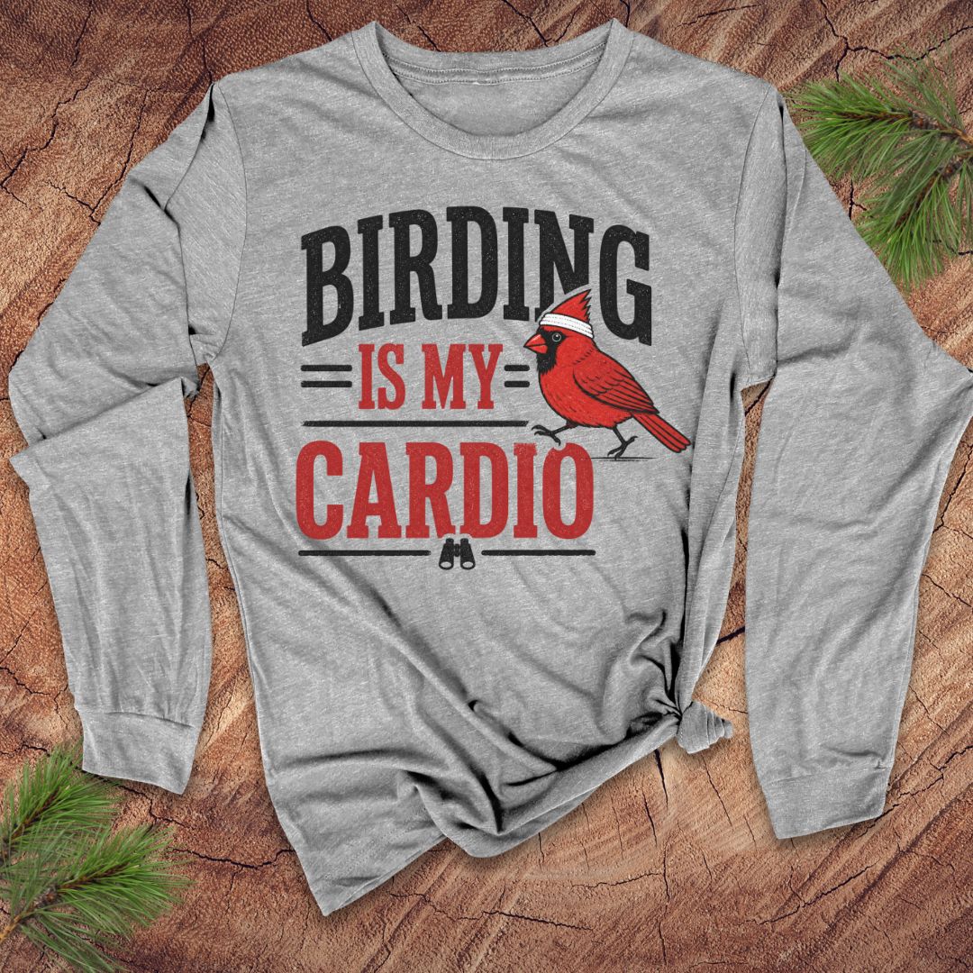 Gray long-sleeve t-shirt with text 'birding is my cardio' and cardinal on a wood background.