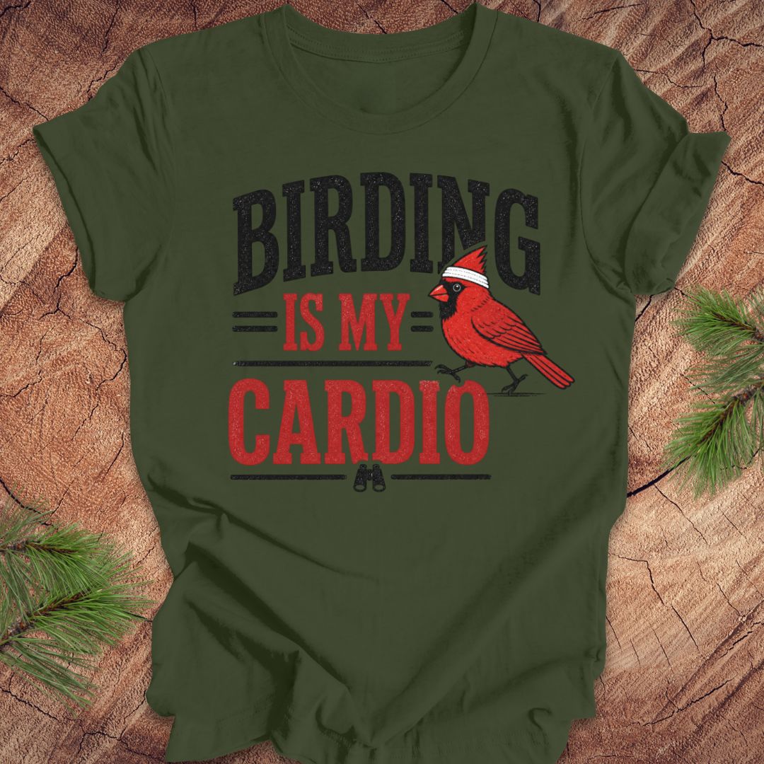 Green t-shirt with 'BIRDING IS MY CARDIO' text and a red cardinal graphic on a wooden surface.