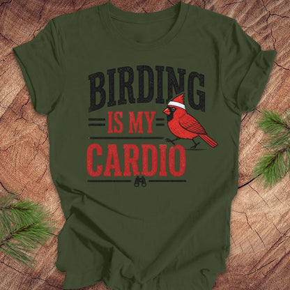Green t-shirt with 'BIRDING IS MY CARDIO' text and a red cardinal graphic on a wooden surface.