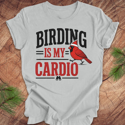 Gray t-shirt with 'BIRDING IS MY CARDIO' text and a red cardinal graphic on a wooden surface.