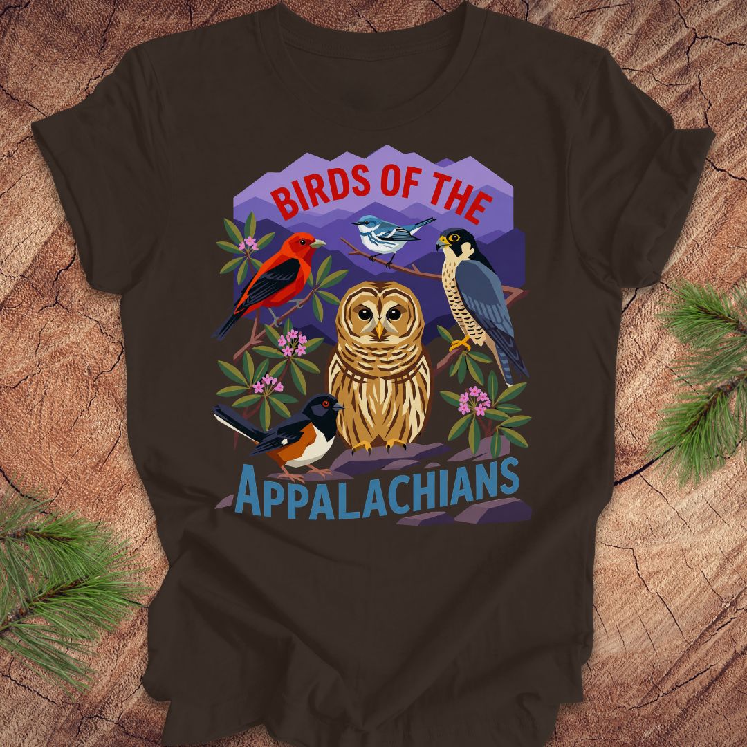 Brown t-shirt with 5 birds and text, 'birds of the appalachians' on a wood background.
