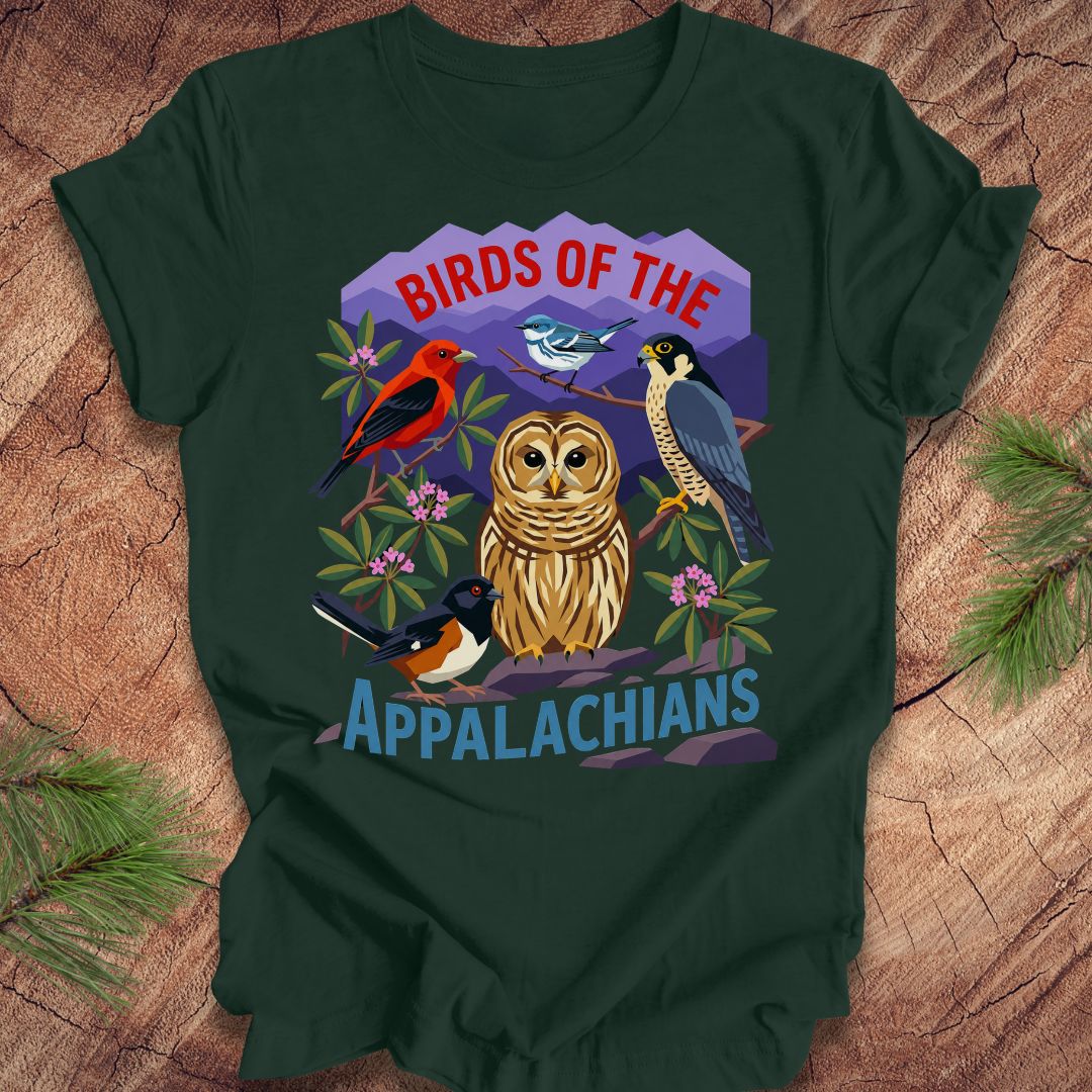 Green t-shirt with 5 birds and text, 'birds of the appalachians' on a wood background.