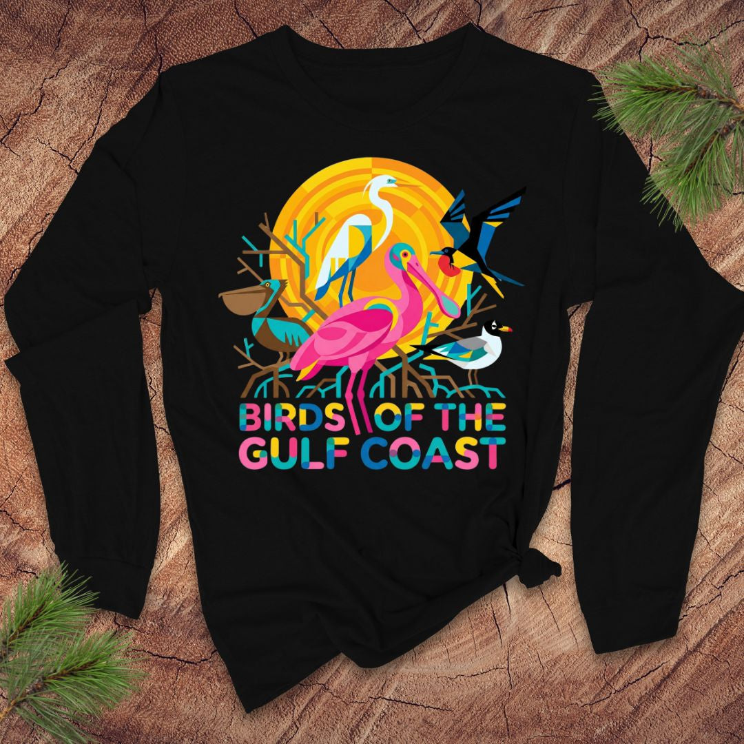 Black long-sleeve tshirt with colorful 'Birds of the Gulf Coast' design on a wooden surface.