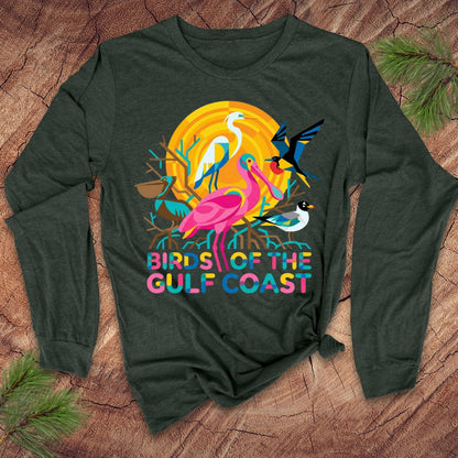 Green long-sleeve shirt with colorful bird design and 'Birds of the Gulf Coast' text on a wooden surface.