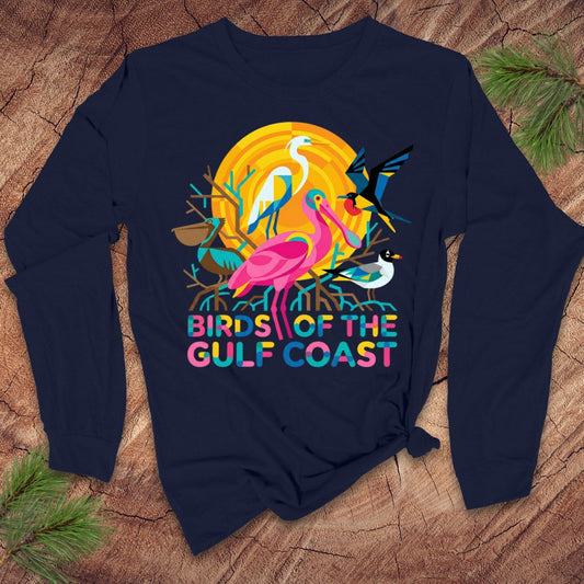 Navy blue long-sleee tshirt with colorful 'Birds of the Gulf Coast' design on a wooden surface.