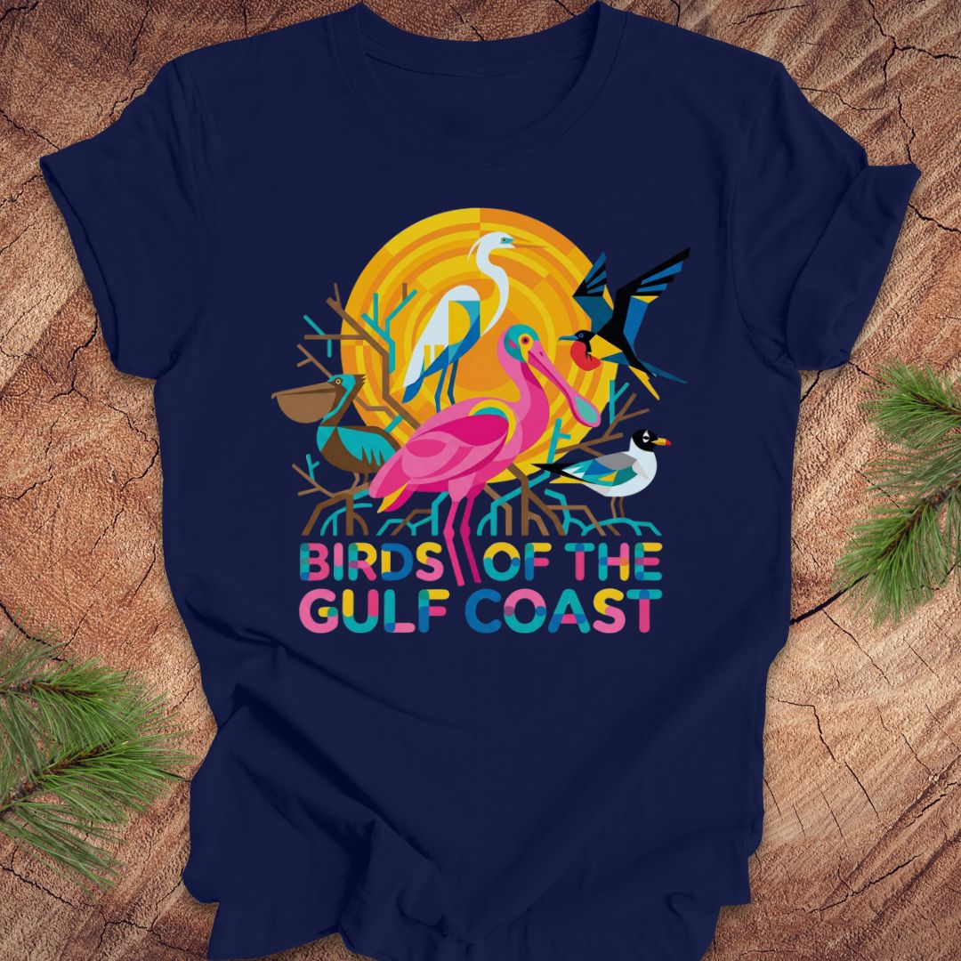 Navy blue t-shirt with bird design and text, 'birds of the gulf coast' on a wooden background.